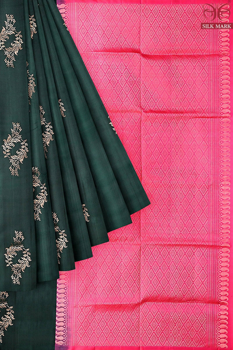 A silk marked kanchivaram handloom saree with the body in dark green and pall in ruby pink color with floral motifs in silver & copper zari.