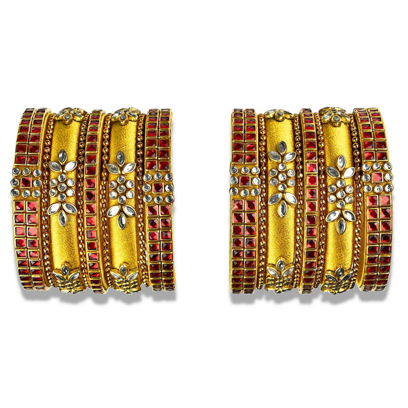 A glittering set of silk thread bangles embellished with red kundan stones in gold silk thread with unique floral design.