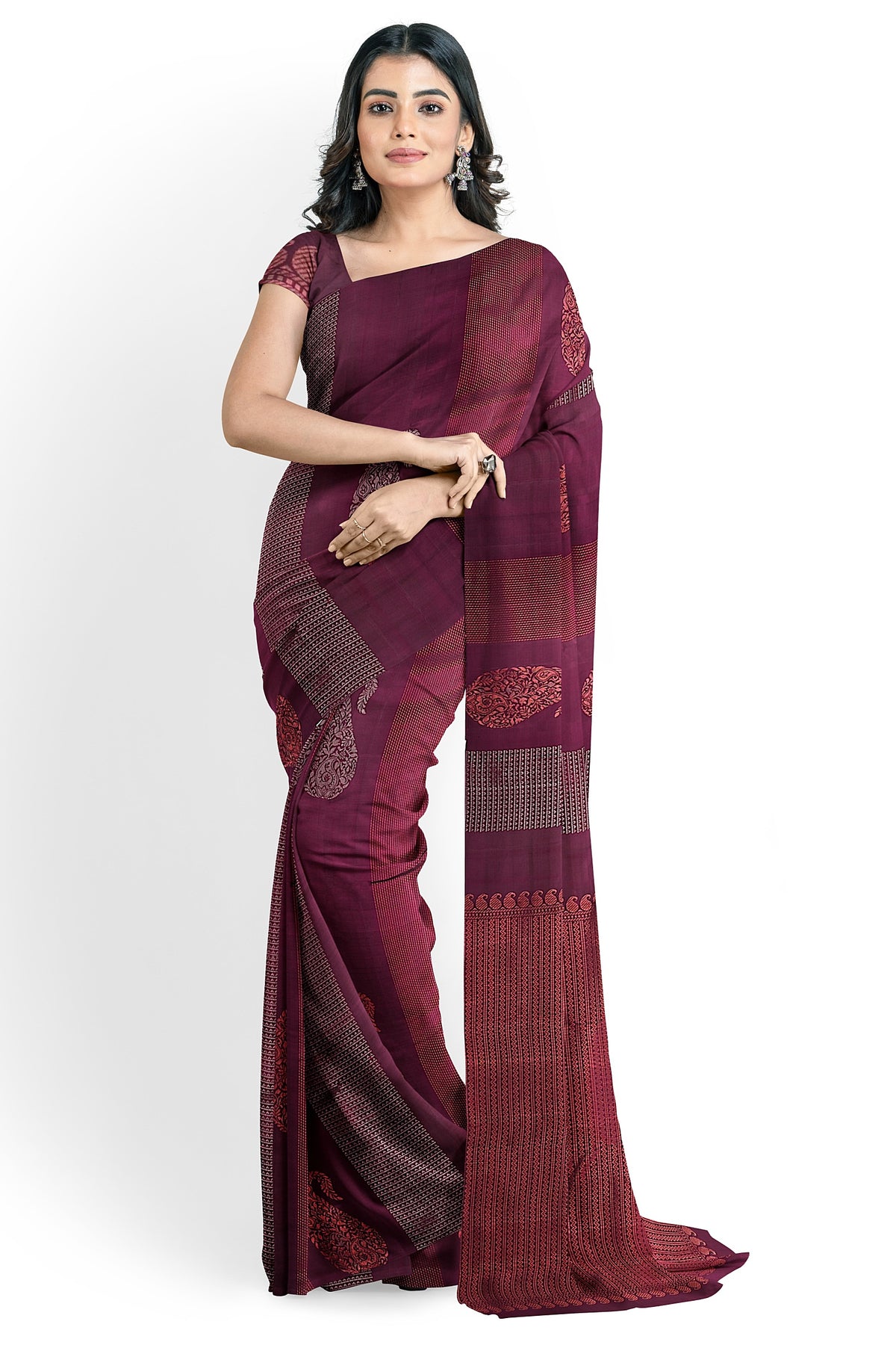 A model draped in a rich and lustrous maroon colored soft silk handloom saree with maroon body & pallu. The saree is designed with paisley & geometrical motifs in silver & copper zari works. The saree comes with an attached running blouse.