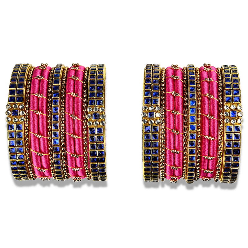 A sparkling set of silk thread bangles embellished with dark blue kundan stones in pink silk thread with unique floral design.